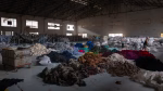 Sortarea a sute de tone de haine într-o fostă fabrică, într-o inițiativă socială dedicată reutilizării textilelor. Sursa foto: Francois Le Nguyen/Unsplash